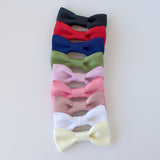 Matte satin bow ties in 10 colors from black to white, sized for newborns to men
