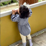 Little girl looking out the window wearing an ivory 4 inch satin hair bow