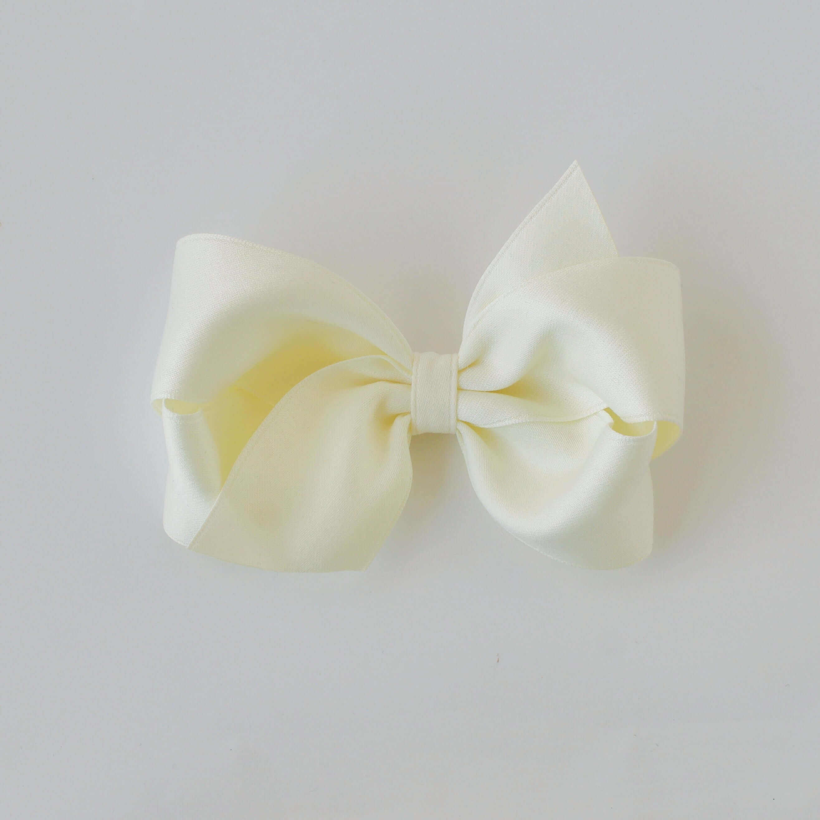 Sustainable recycled polyester 4 inch matte satin hair bow for toddlers to girls in ivory