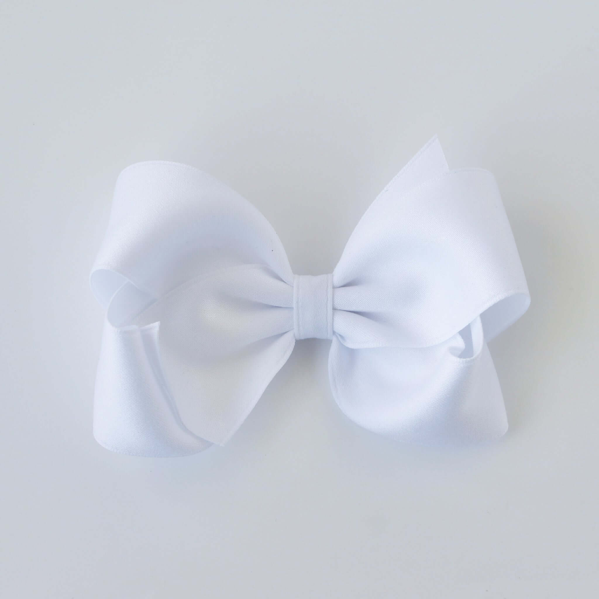 Sustainable recycled polyester 4 inch matte satin hair bow for toddlers to girls in white