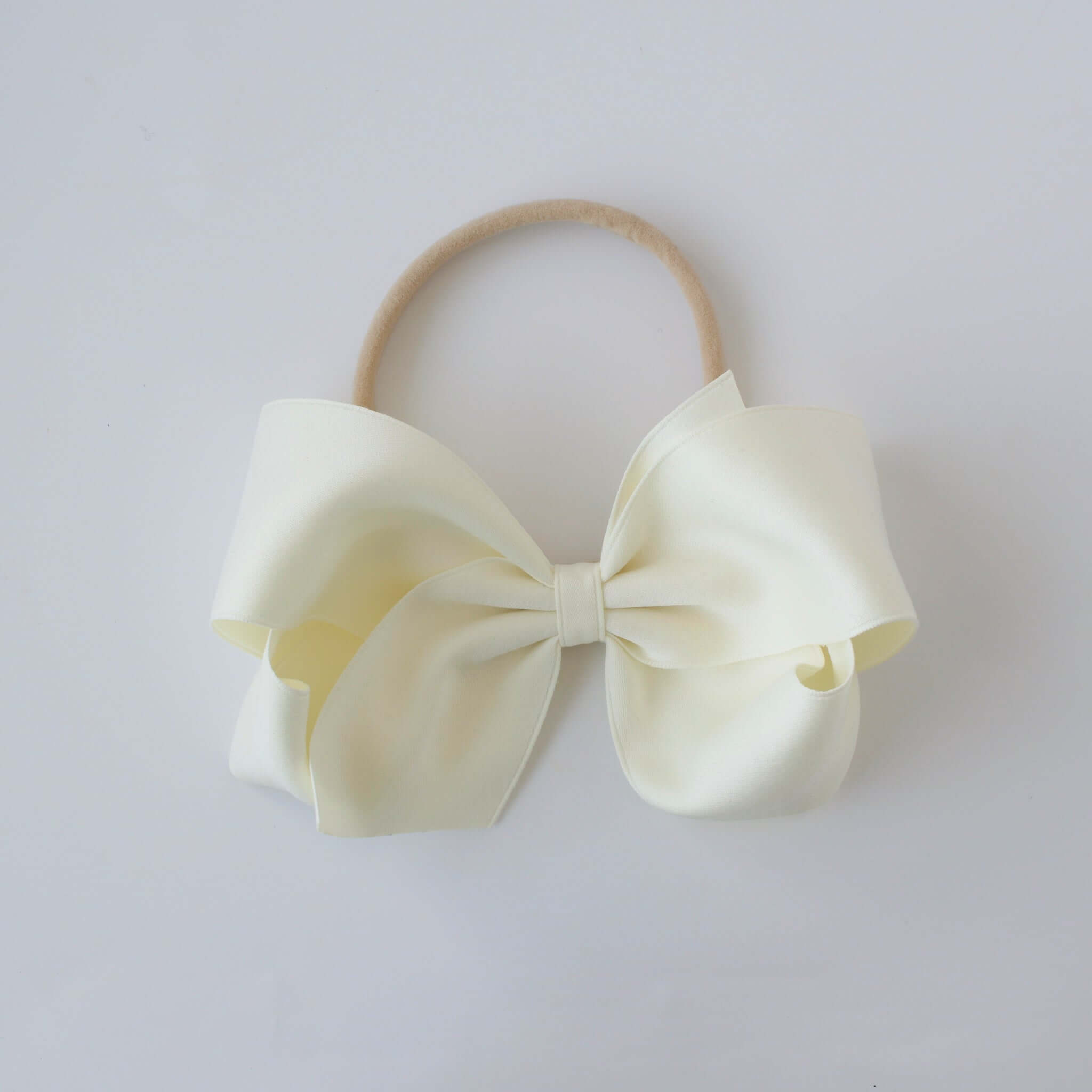 Sustainable recycled polyester matte satin bow headband for newborn to girls in ivory