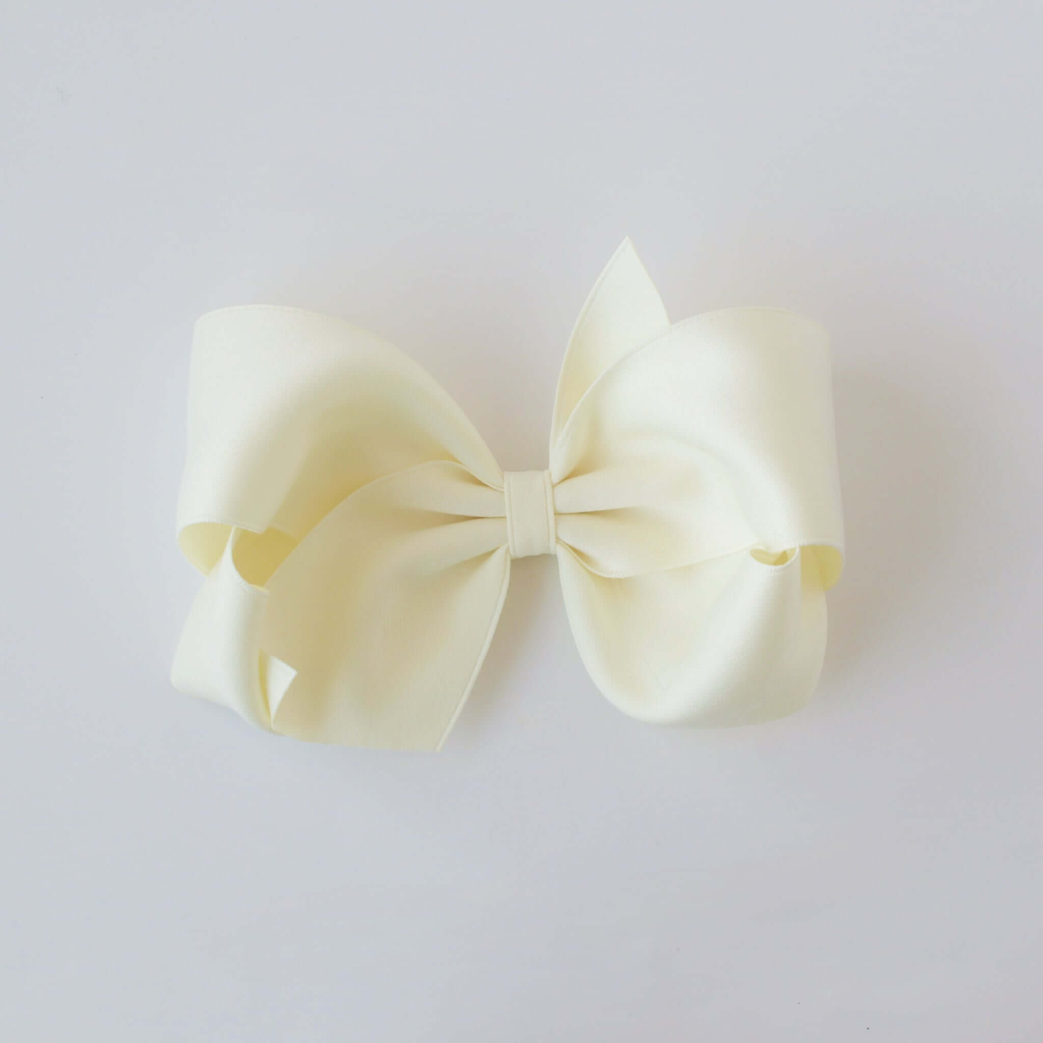Sustainable recycled polyester 5 inch matte satin hair bow for toddlers to girls in ivory
