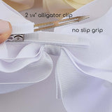 Alligator clip with white ribbon and text indicating size and feature