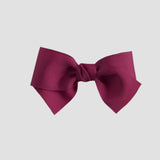 Azalea pink hair bow on a white background