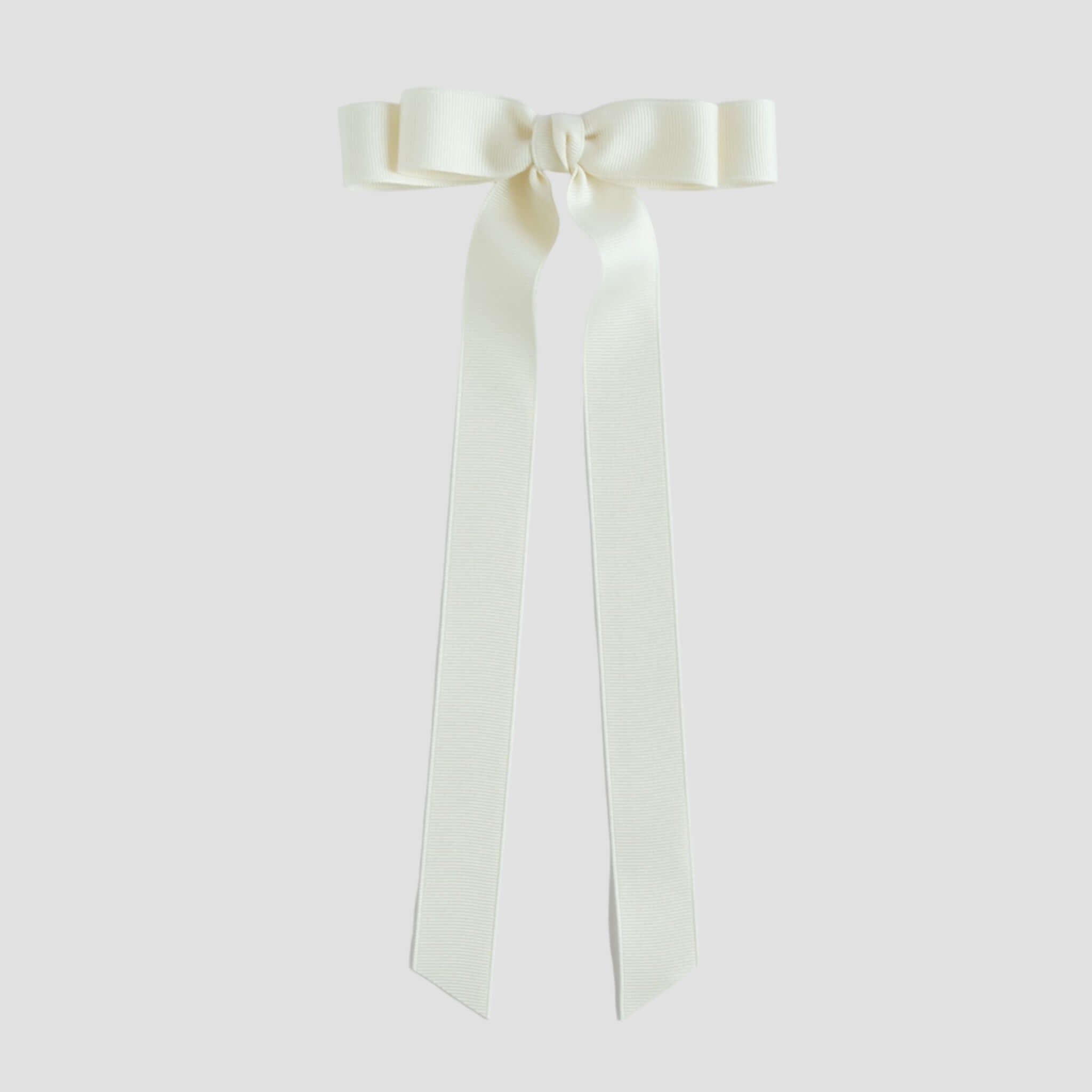 Ivory bow with long tails on a white background