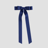 Light navy bow with long ribbons on a white background