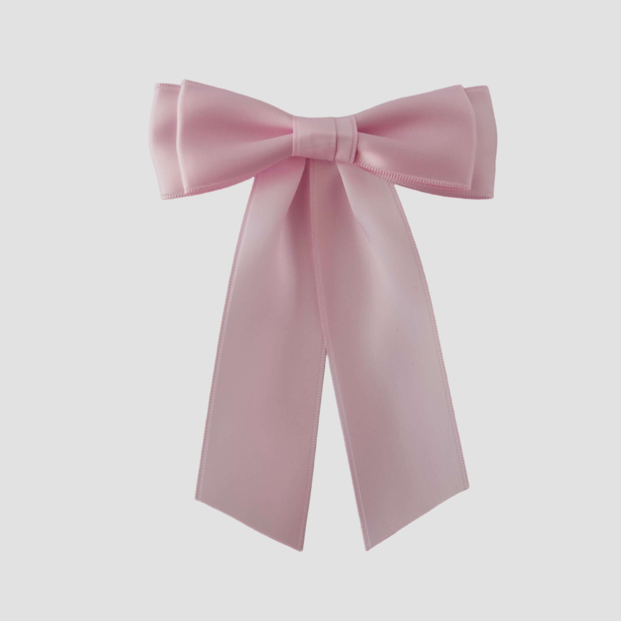 Mia Satin Hair Bow in light pink on a white backgound