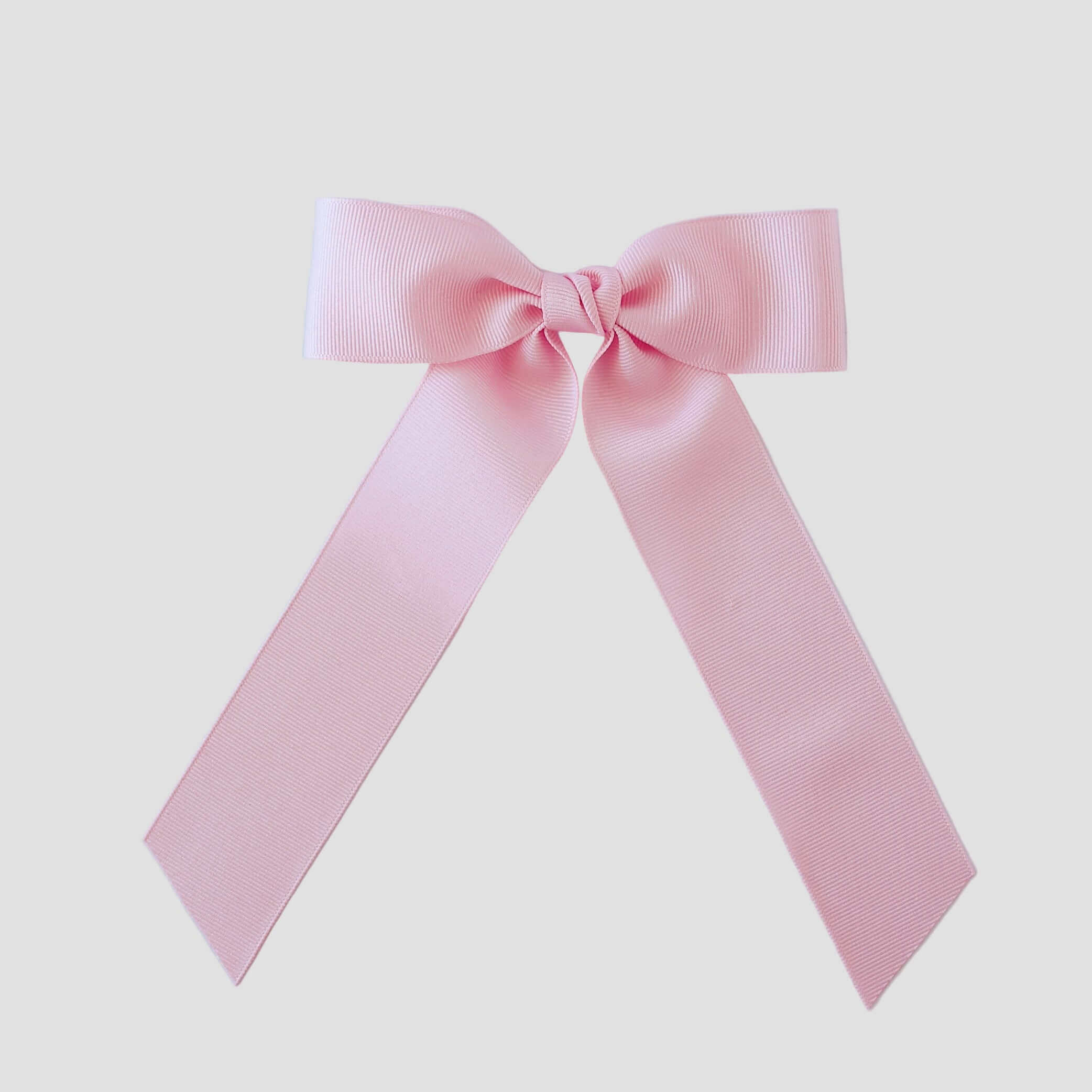 Light pink grosgrain Zoe Petite bow on a white background