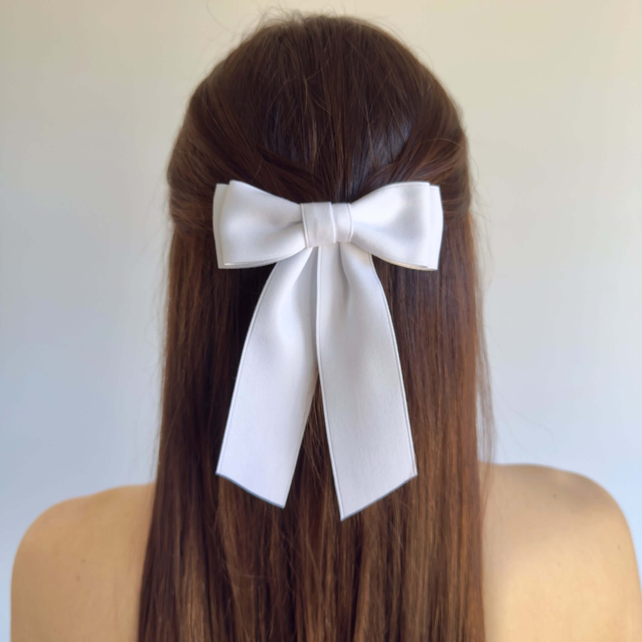 Handmade Mia Matte Satin Bow in white, perfect for young girls and women with short hair, showcasing sustainable style.