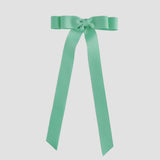 Mint green ribbon bow on a white background