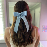Model wearing Zoe Petite bow in blue