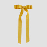 Mustard yellow grosgrain ribbon bow on a white background