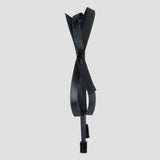 A black satin headband with a bow design in the center, displayed against a white background.