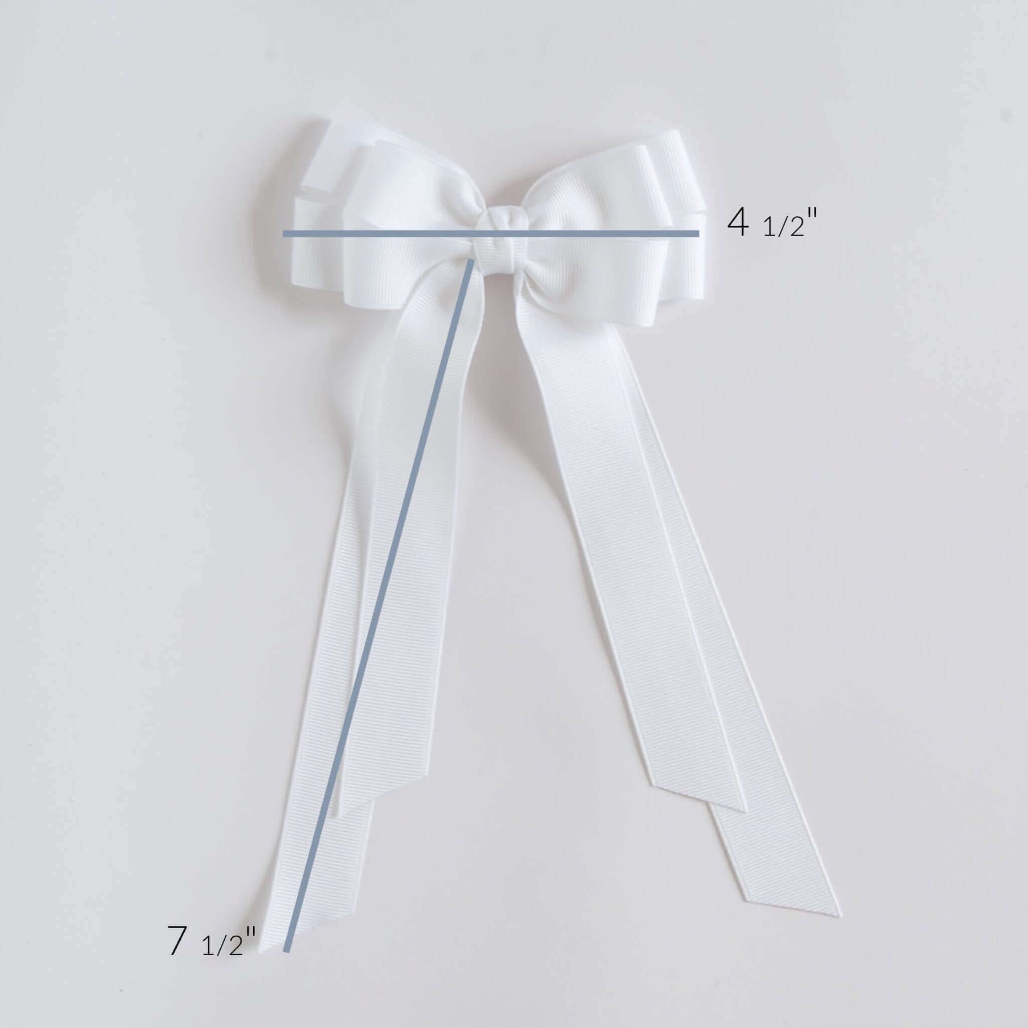 White bow with measurements on a light gray background