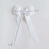 White bow with measurements on a light gray background
