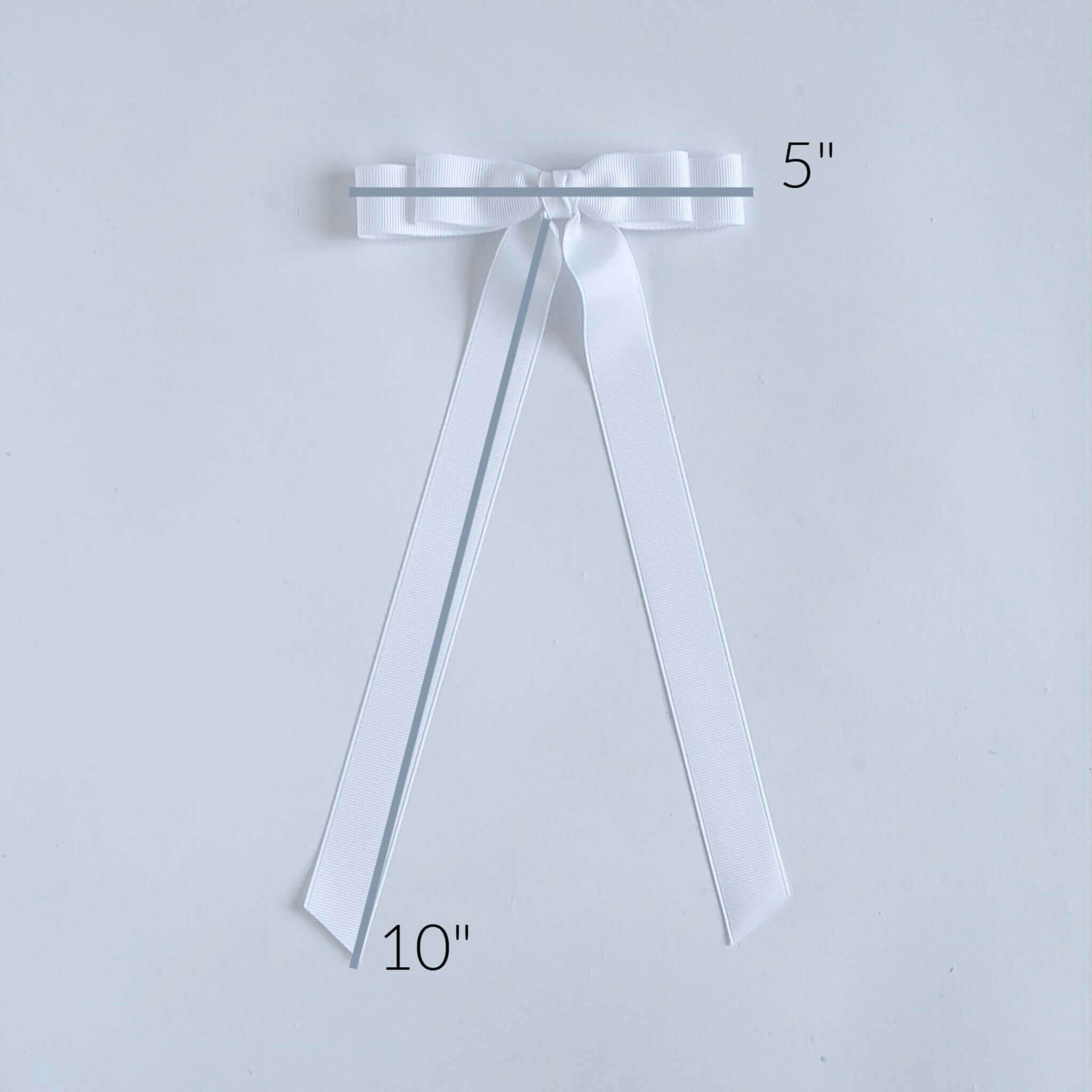 Ruler measurement on a white Bailee grosgrain bow.