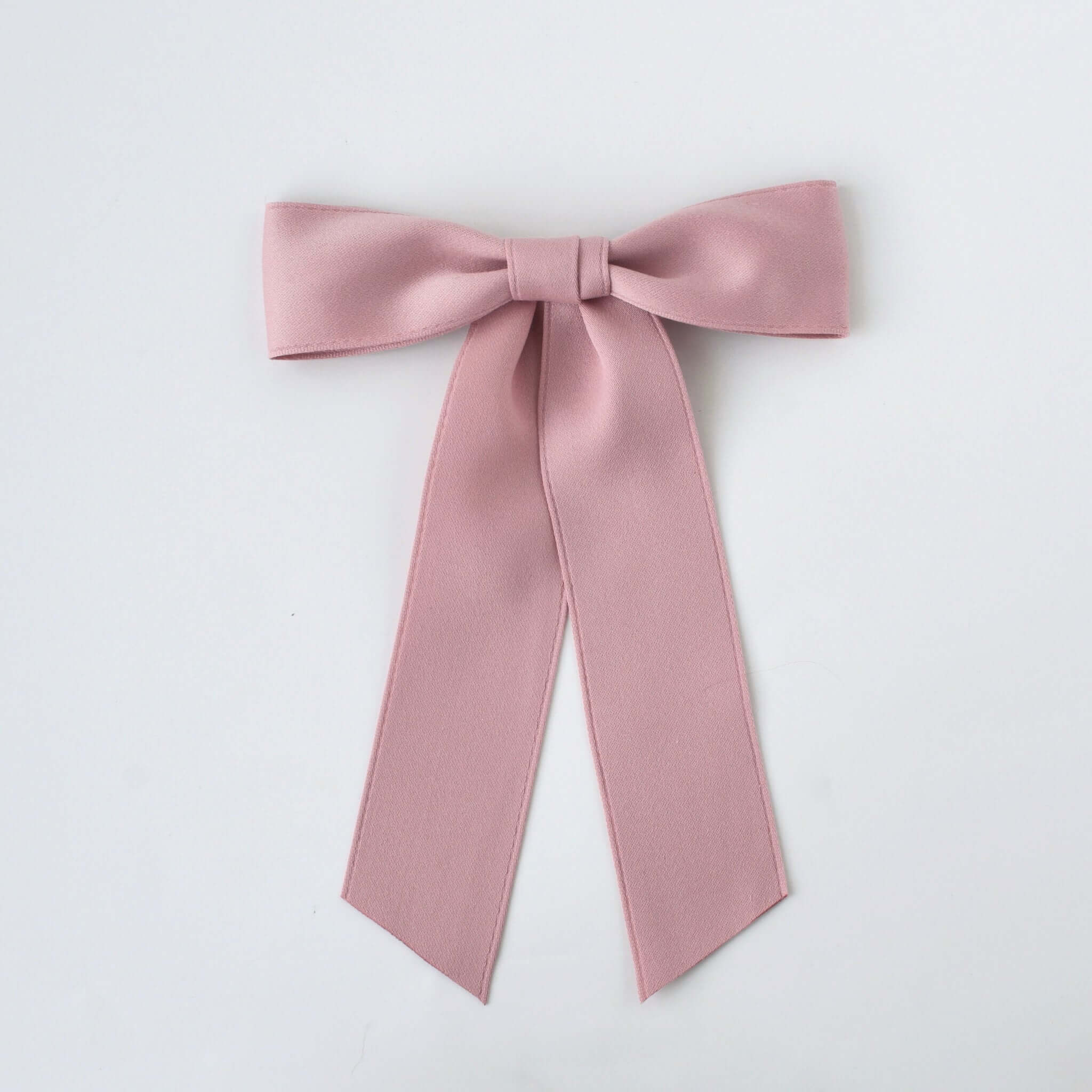 Sustainable recycled matte satin ribbon hair bow for women and girls in soft pink color.