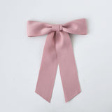 Sustainable recycled matte satin ribbon hair bow for women and girls in soft pink color.