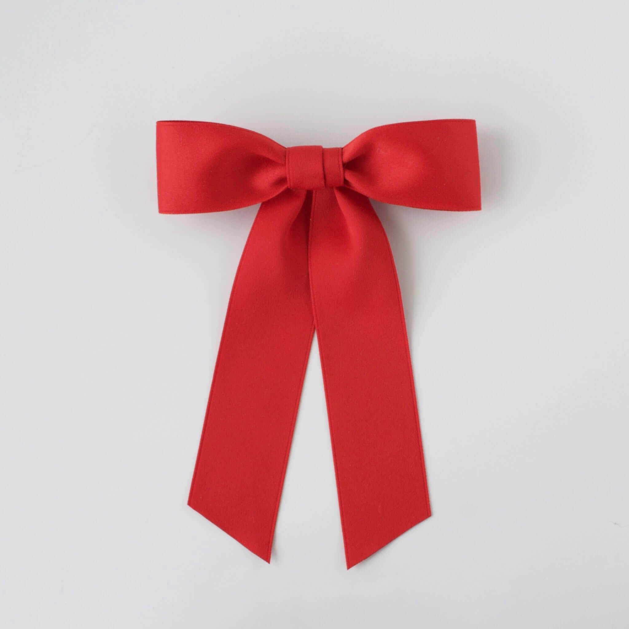 Sustainable recycled matte satin ribbon hair bow in vibrant red for women and girls, perfect for versatile styling.