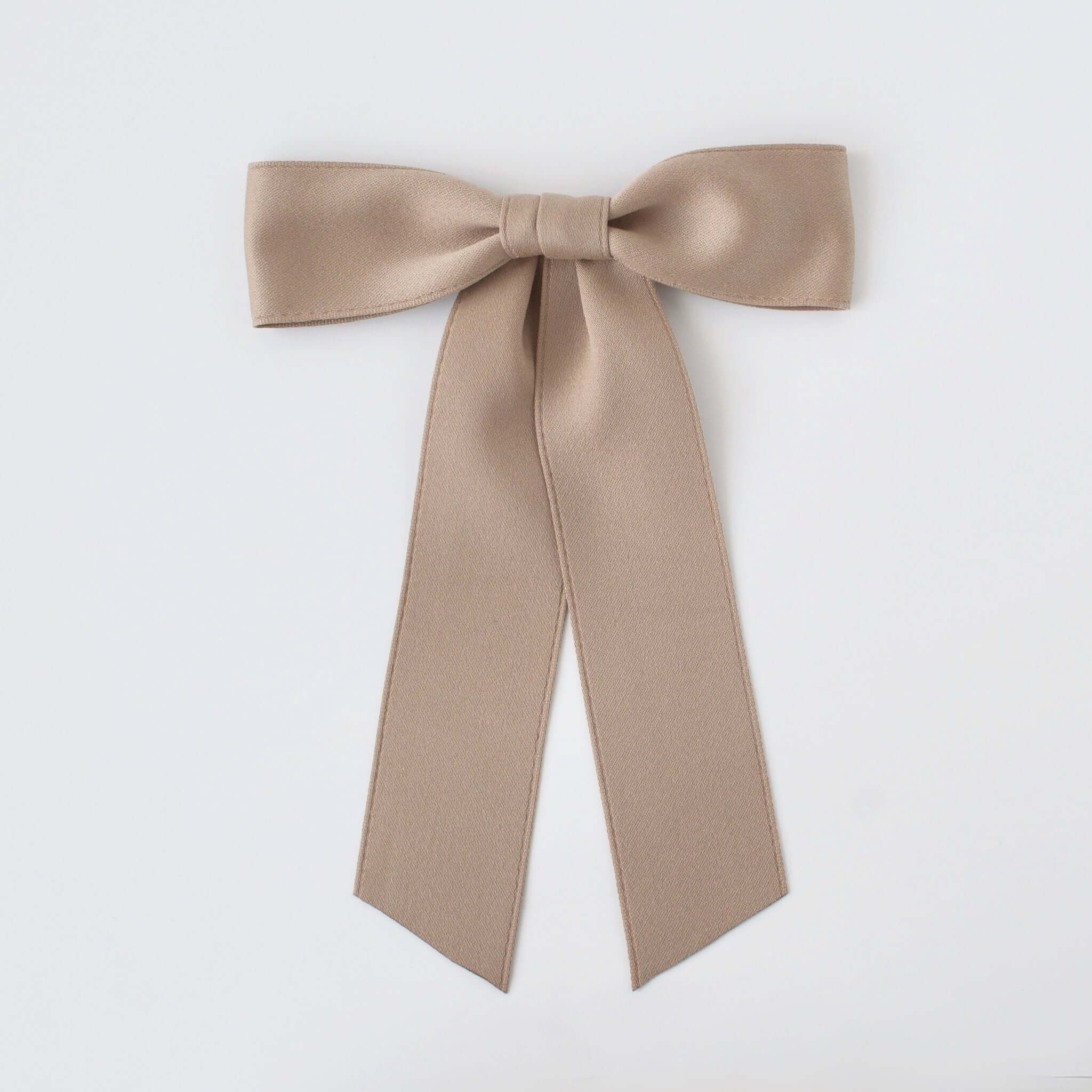 Sustainable recycled matte satin ribbon hair bow for women and girls in neutral beige color.