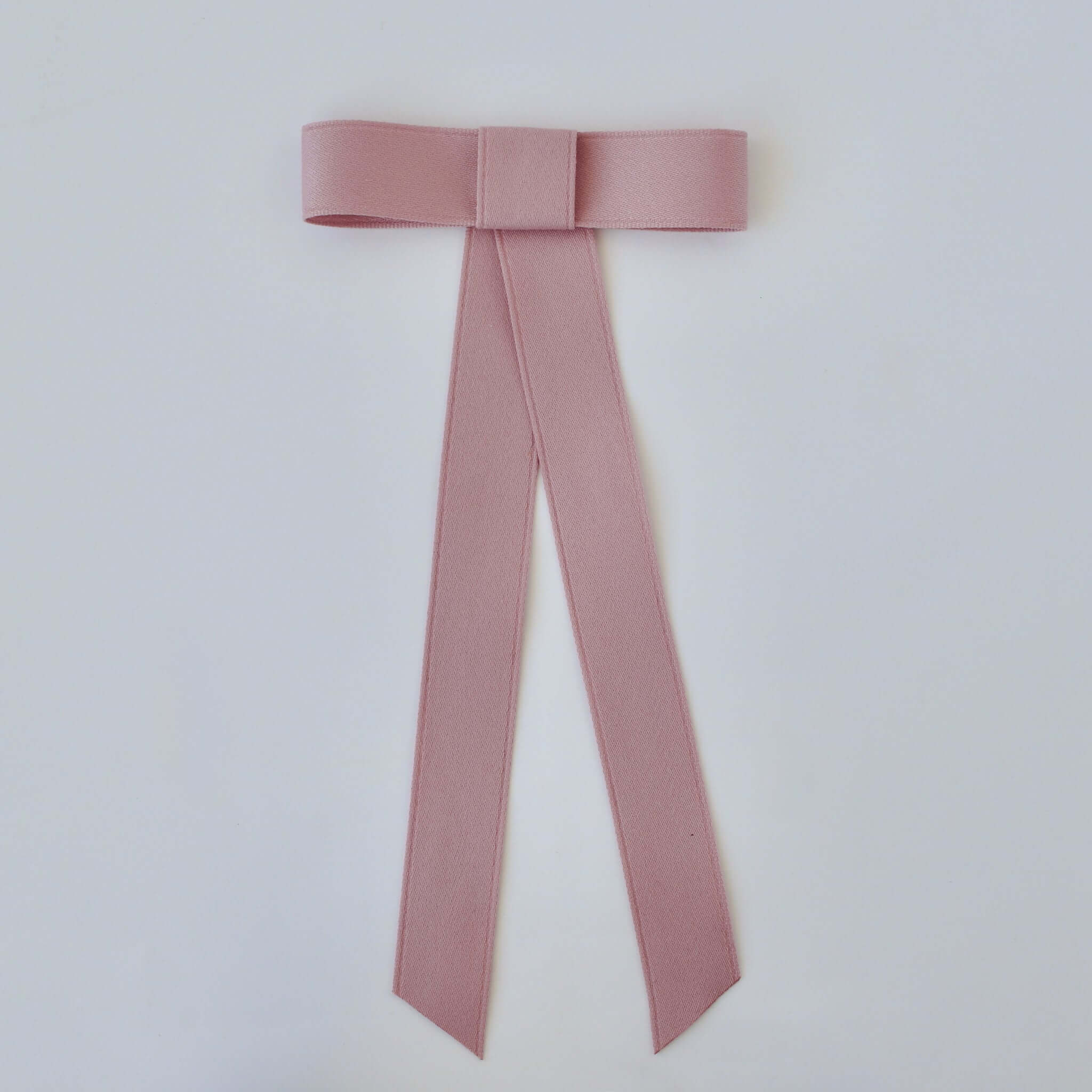 Zoe Mini Matte Satin Bow in soft pink, handmade with eco-friendly recycled ribbon for stylish versatility.