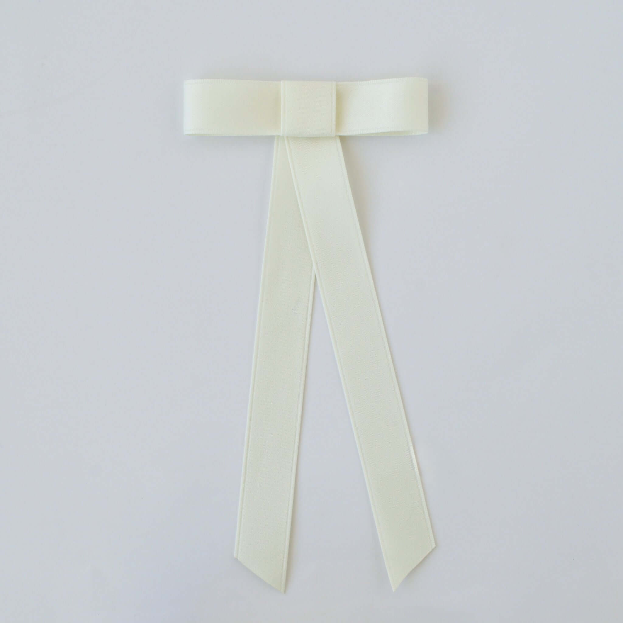 Zoe Mini Matte Satin Bow in ivory, handmade with eco-friendly recycled ribbon, perfect for hair styling and special occasions.