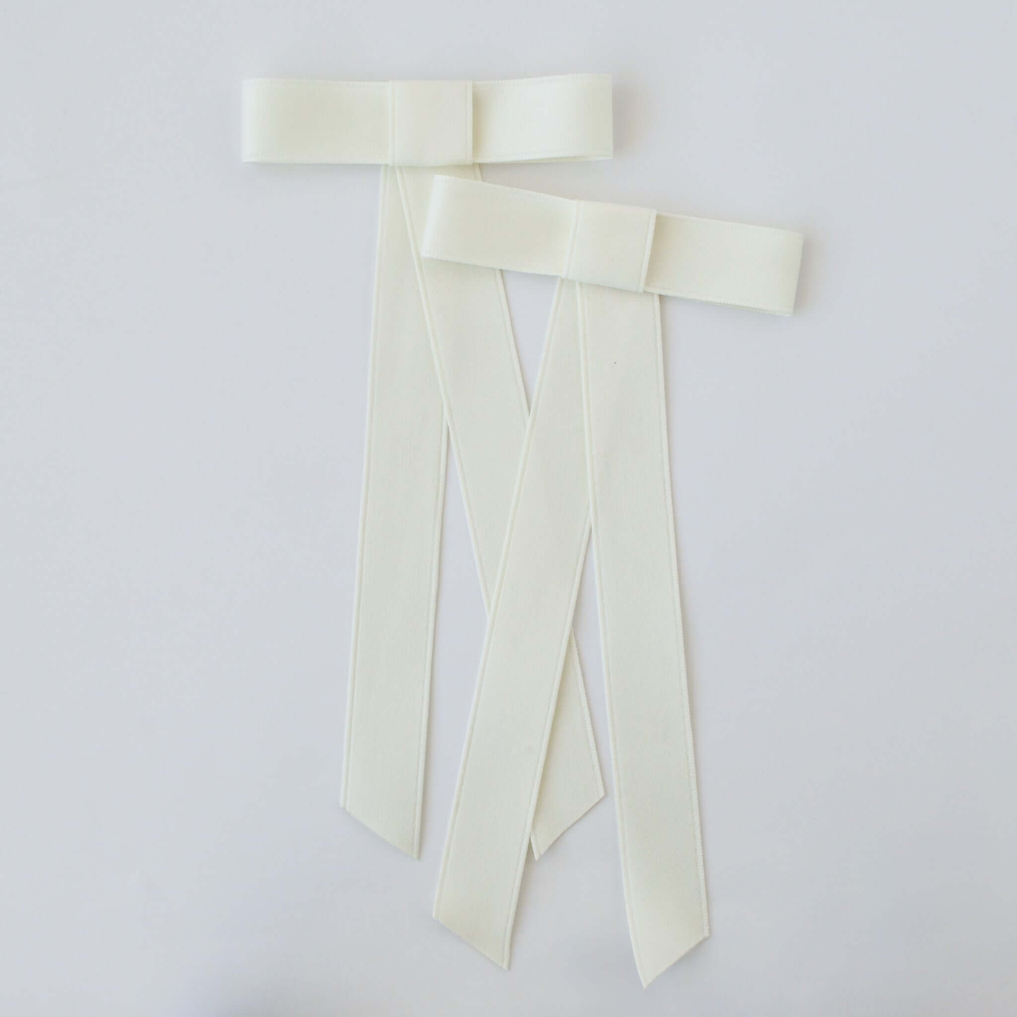 Zoe Mini Matte Satin Bow set in ivory, made from eco-friendly recycled material, perfect for versatile hairstyles.