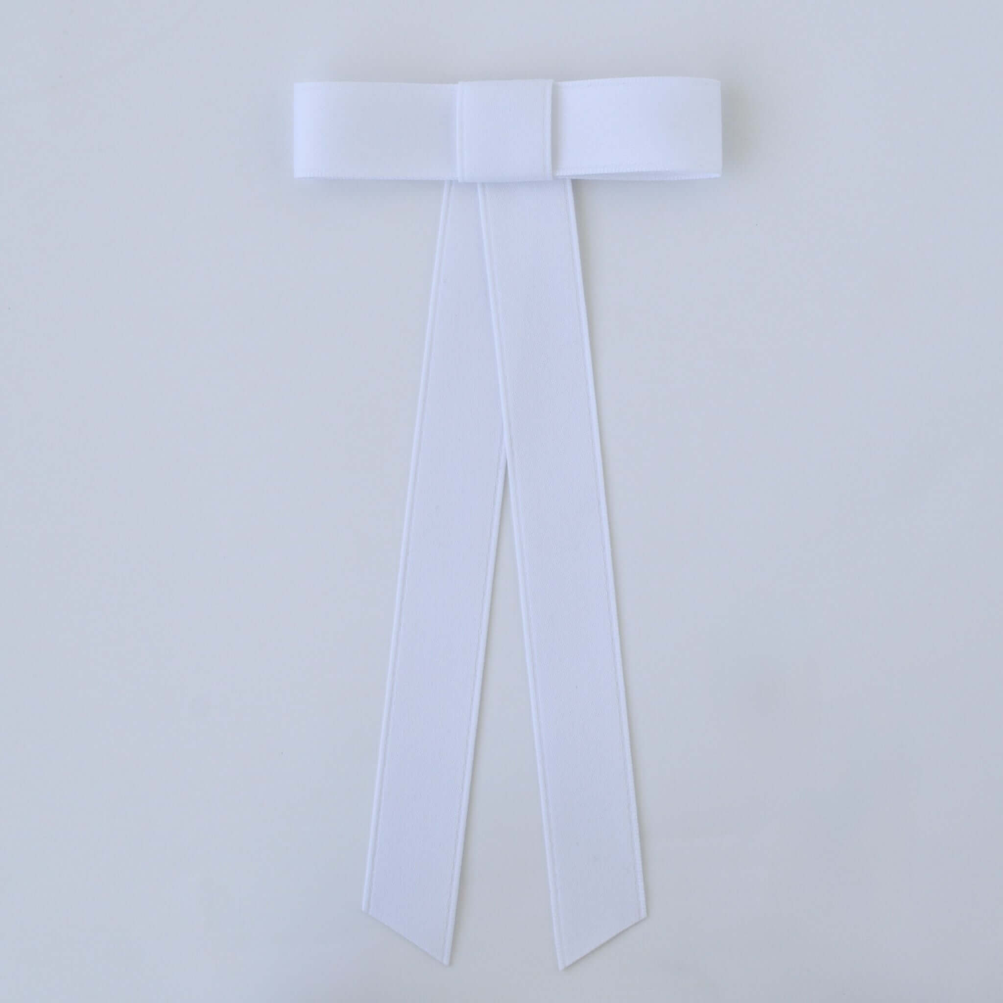 Zoe Mini Matte Satin Bow in white, handmade with sustainable recycled ribbon, ideal for versatile hair styling.