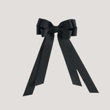 Black bow with long tails on a white background
