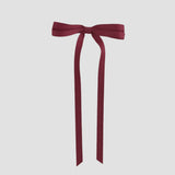 Cranberry red ribbon bow on a white background