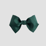 Forest green hair bow on a white background