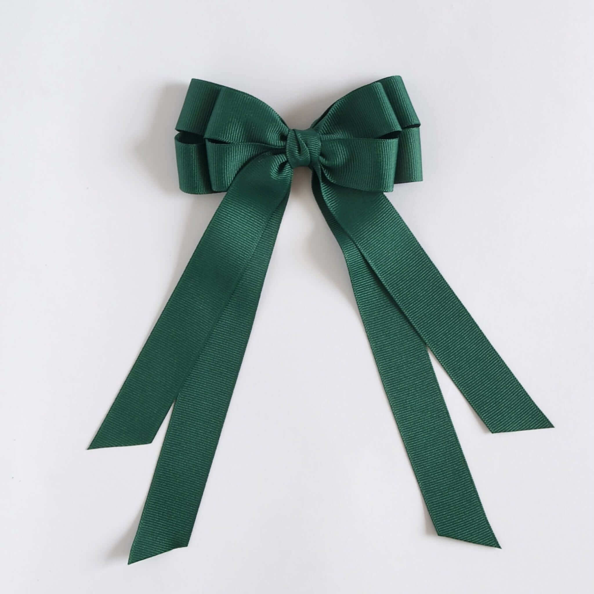 Forest green ribbon bow on a white background