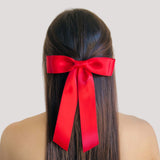 Red satin ribbon hair bow – stylish accessory for girls and women.