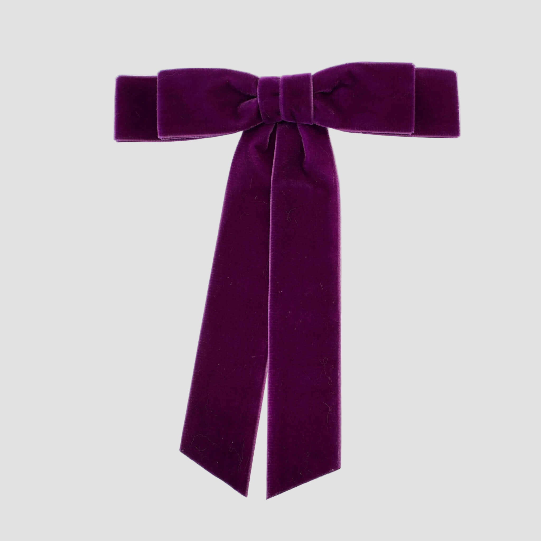 Grace velvet hair bow in fuchsia purple on a white background.