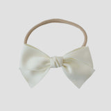 Sustainable recycled polyester matte satin bow headband for newborns to toddlers in ivory