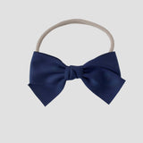 Sustainable recycled polyester matte satin bow headband for newborns to toddlers in navy