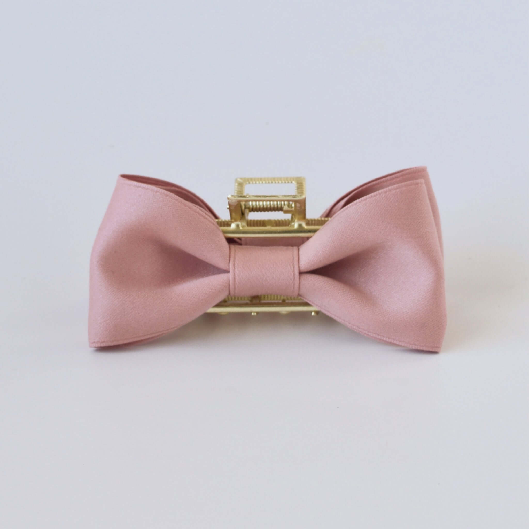 Dusty rose matte satin bow claw clip with gold clasp – elegant hair accessory for women and girls.