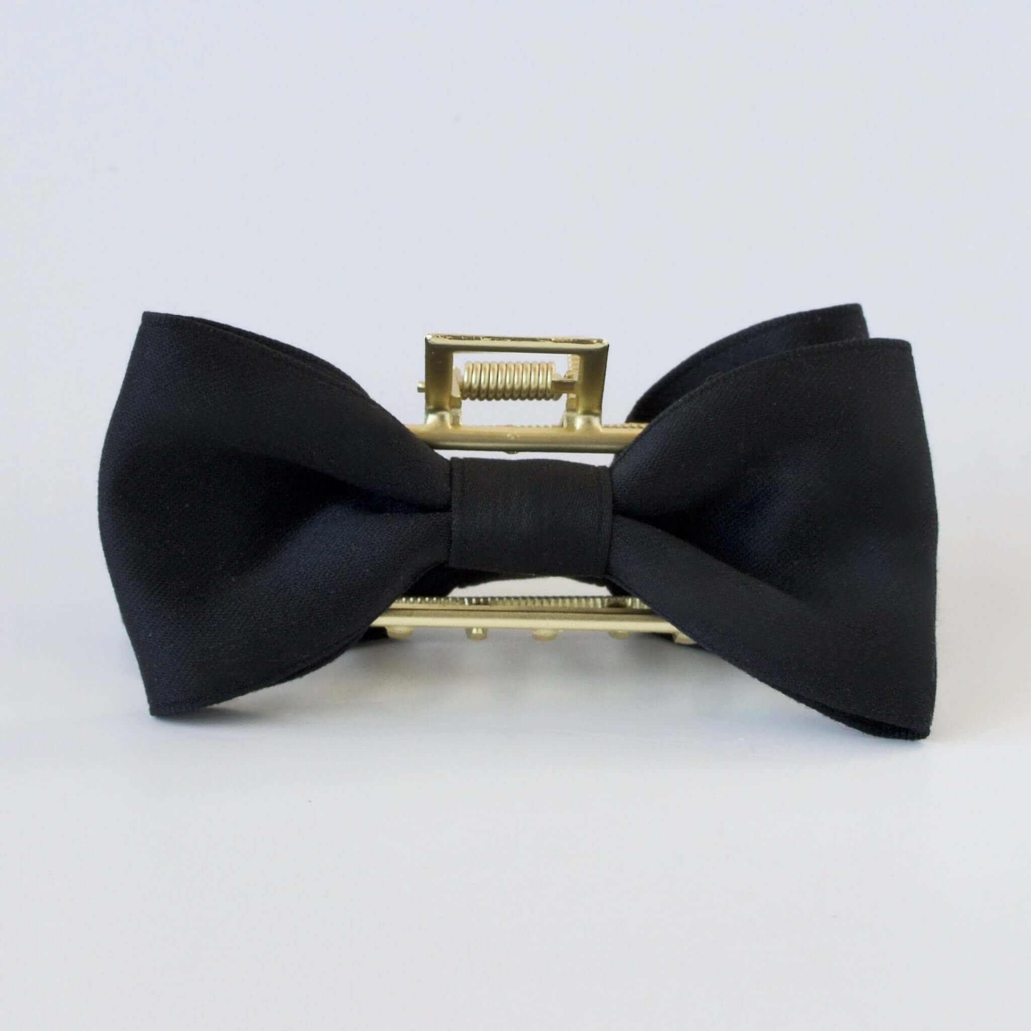 Black satin bow claw clip with gold clasp – trendy hair accessory for women and girls.