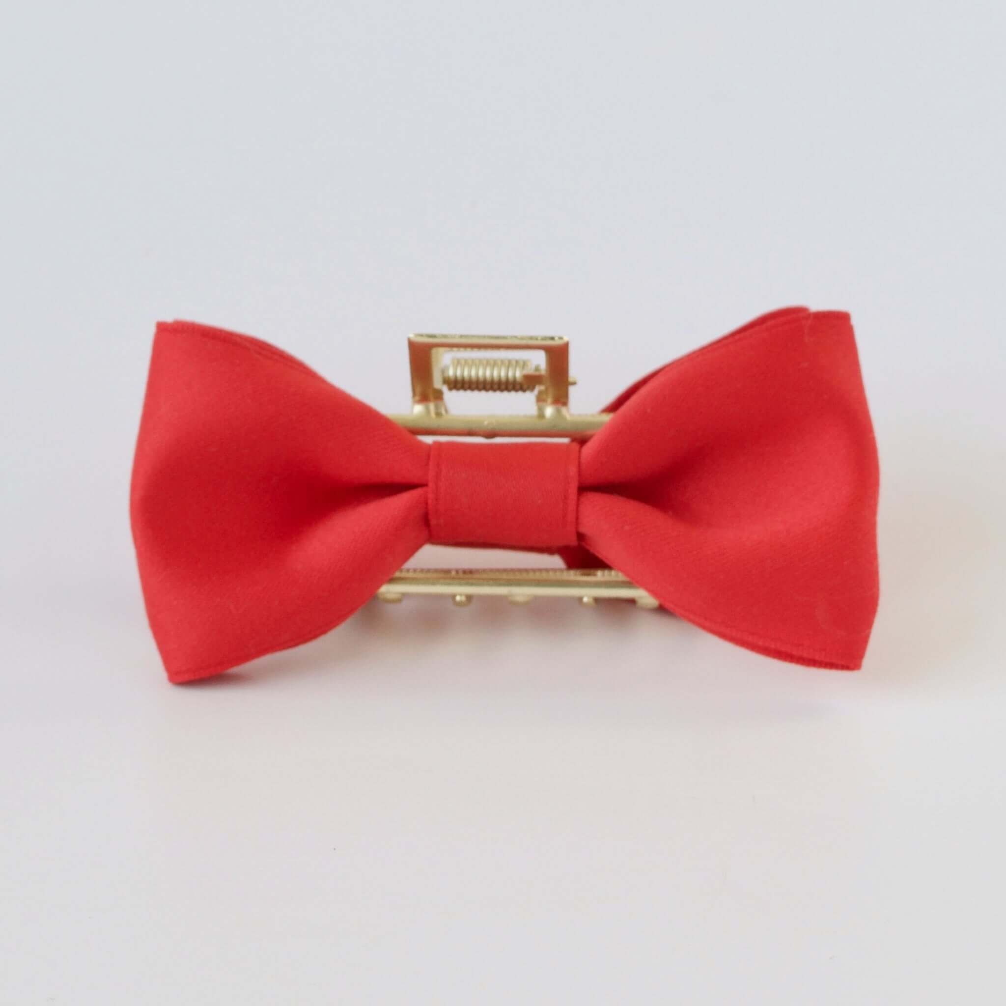 Red satin bow claw clip with gold clasp – elegant hair accessory for women and girls.