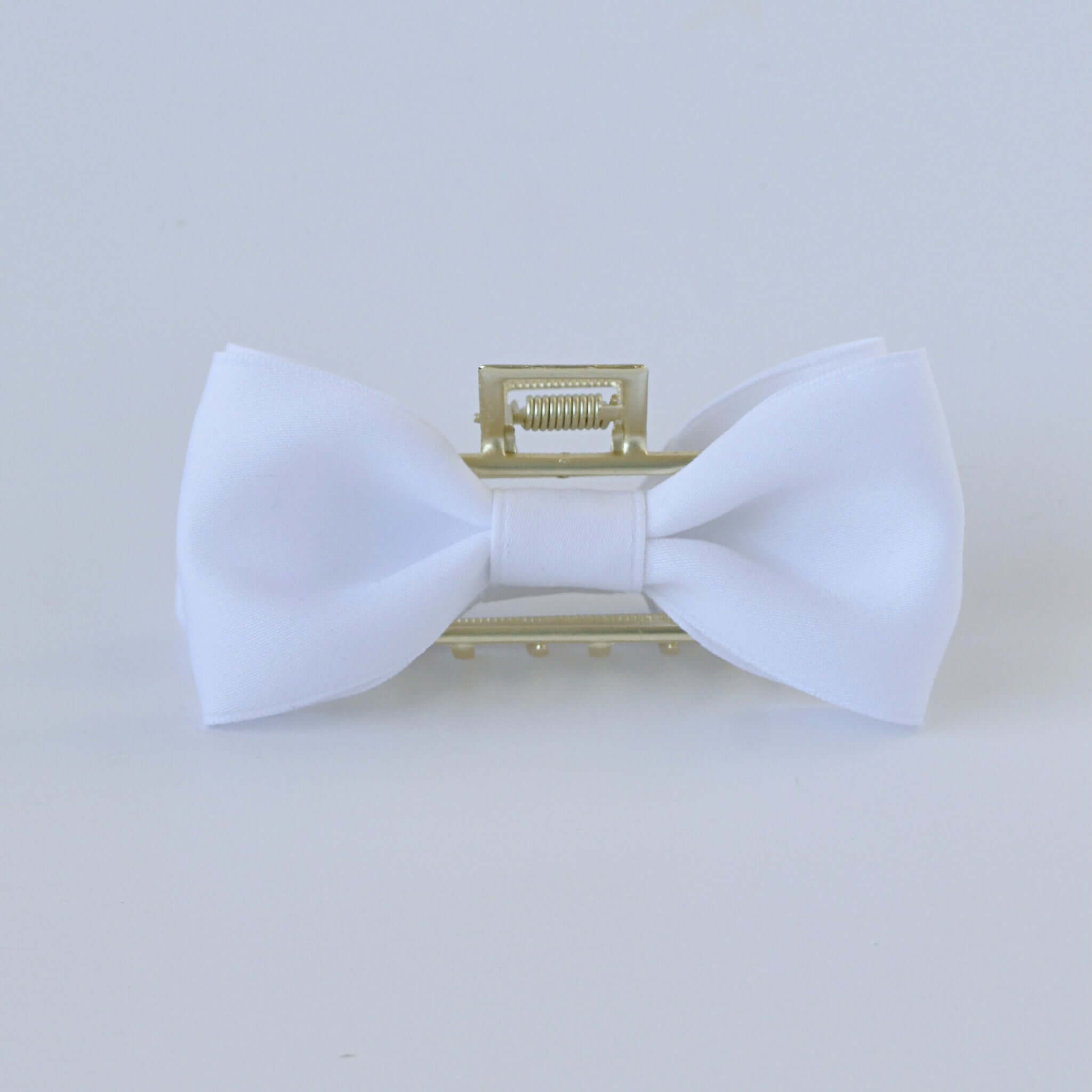 White matte satin bow claw clip with gold clasp – elegant hair accessory for brides.
