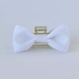 White matte satin bow claw clip with gold clasp – elegant hair accessory for brides.