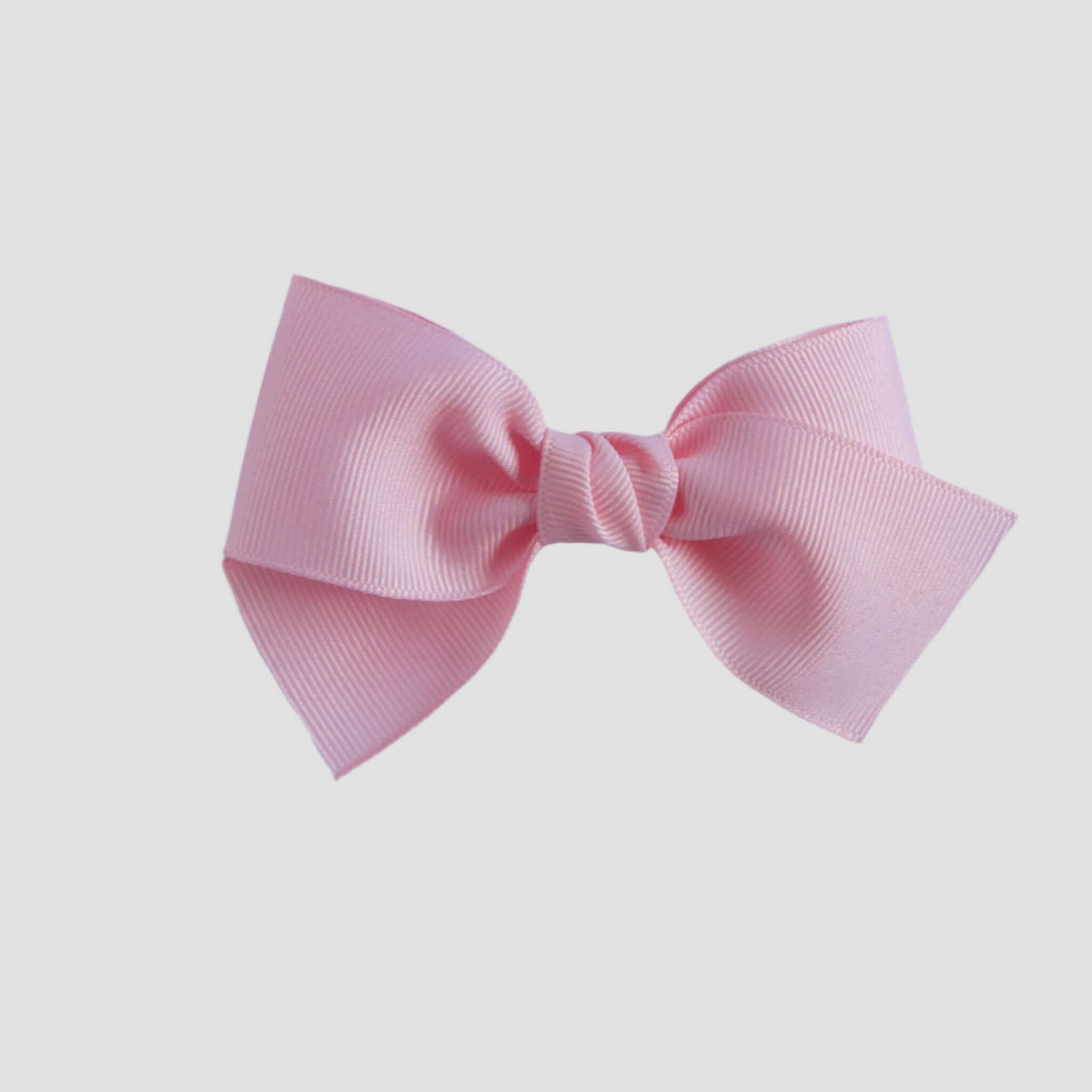 Light pink hair bow on a white background