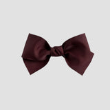 Maroon hair bow on a white background