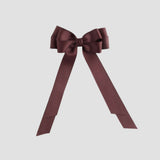 Maroon bow with long tails on a white background