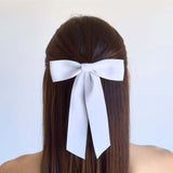 Sustainable recycled matte satin ribbon hair bow elegantly worn for women and girls.