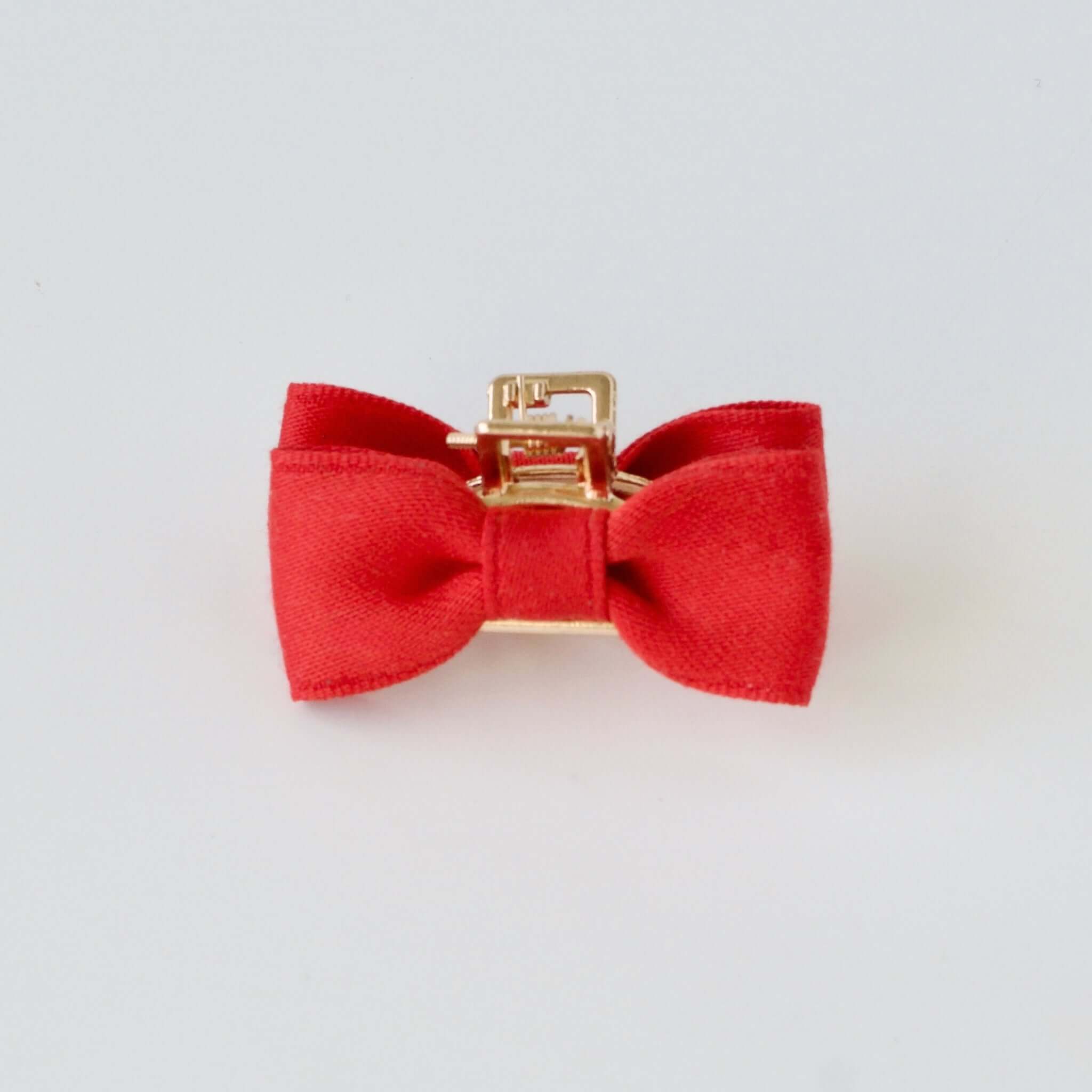 Red satin bow claw clip for everyday wear.