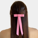 Mini matte satin hair bow in pink, handmade with eco-conscious materials, styled at the back of long hair.