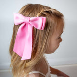 Pink Mia Matte Satin Bow on child's hair, perfect for young girls and toddlers, handmade from eco-friendly satin ribbon.