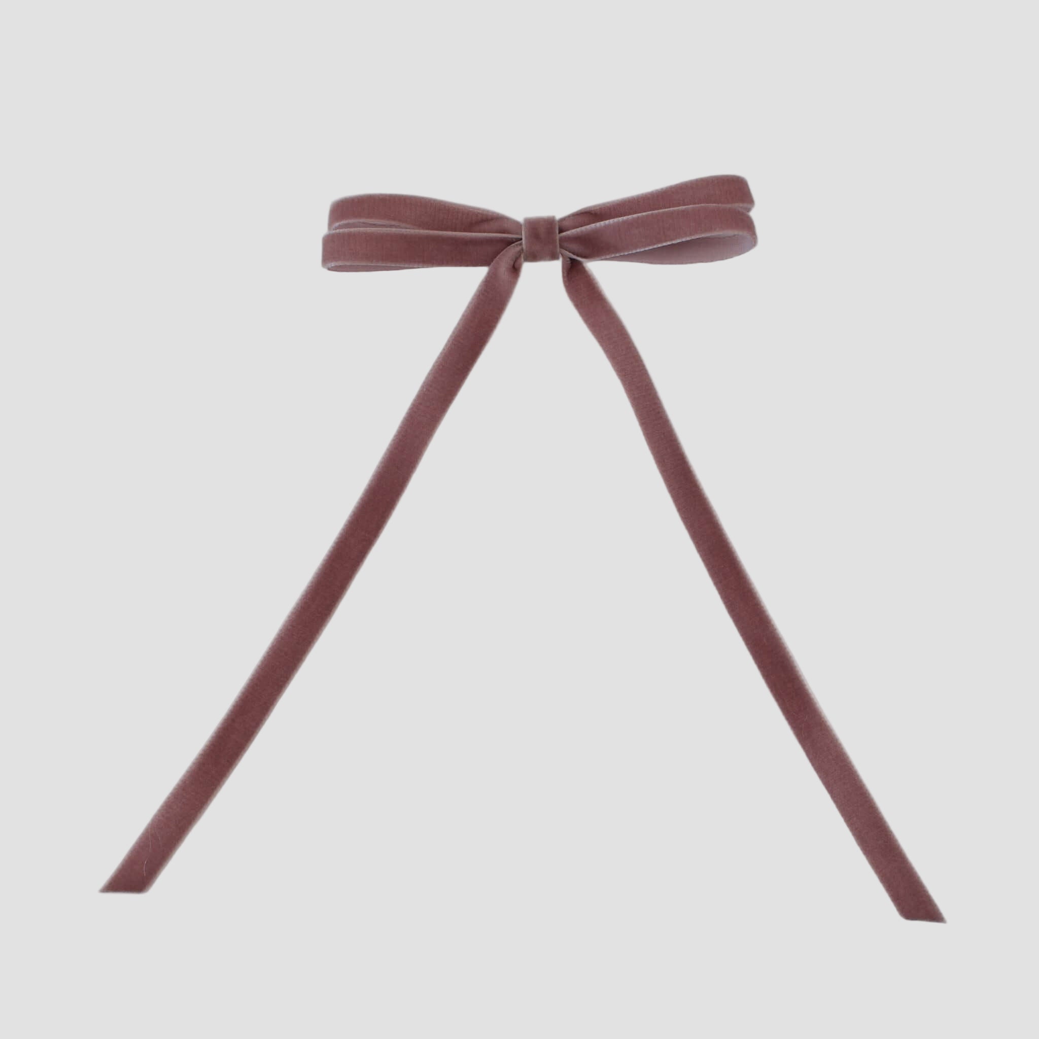 Olivia velvet hair bow in dusty rose pink on a white background