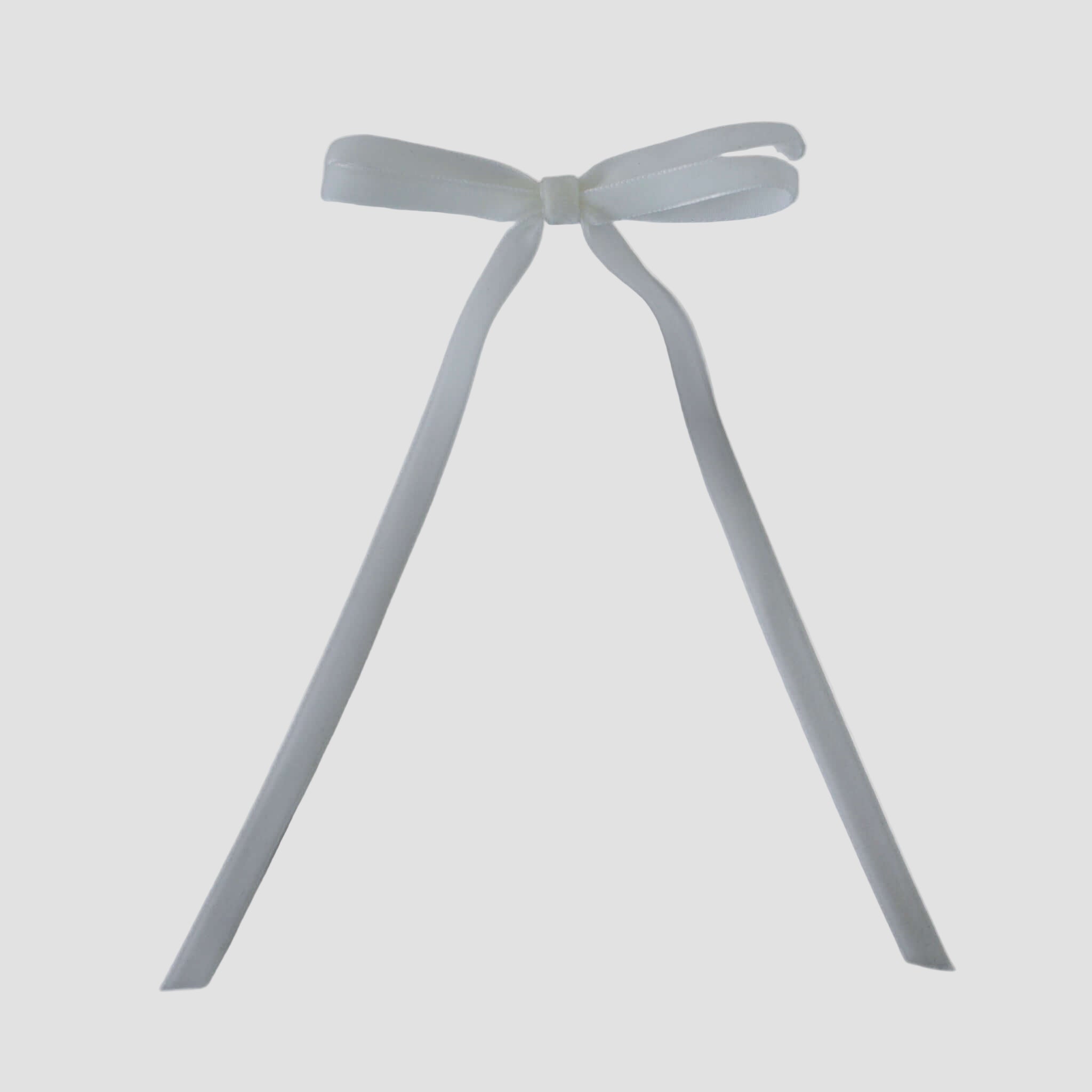 Olivia velvet hair bow in white on a white background